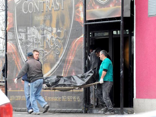 Workers remove a dead body from the nightclub Contrast in Novi Sad, Serbia. Serbian police say six people died in a nightclub fire in the city in the country's north. (AP Photo)
