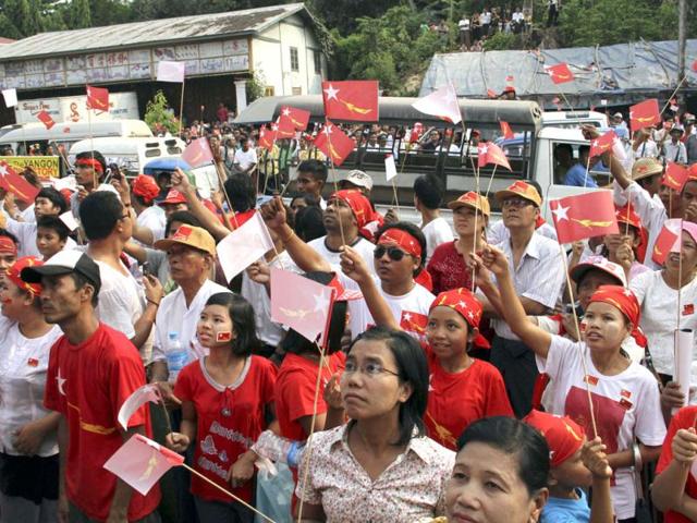 Supporters of Myanmar democracy leader Aung San Suu Kyi's National League for Democracy gather outside the party headquarters as they wait to see the results of the by-election in Yangon, Myanmar. The party said Suu Kyi won a seat in Myanmar's parliament after Sunday's landmark election, setting the stage for her to hold public office for the first time. (AP Photo/Khin Maung Win)