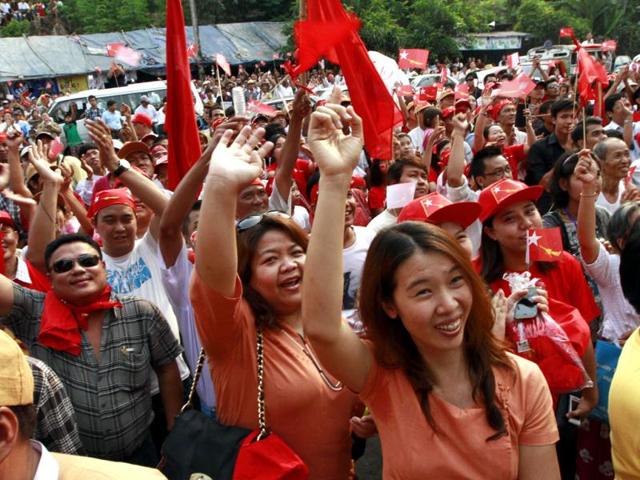 Aung San Suu Kyi's National League for Democracy party supporters cheer upon the party's announcement in Yangon, Myanmar. Supporters of Suu Kyi erupted in euphoric cheers Sunday after her party said she won a parliamentary seat in a landmark election, setting the stage for her to take public office for the first time. (AP Photo/Khin Maung Win)