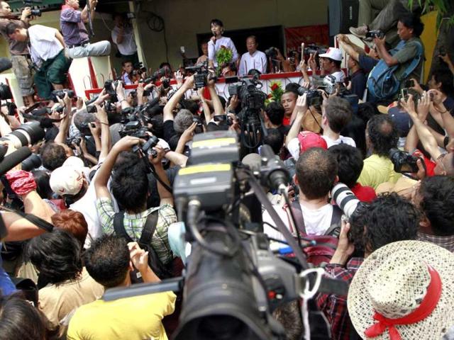 Myanmar pro-democracy leader Aung San Suu Kyi, talks to supporters at the headquarters of her National League for Democracy party in Yangon, Myanmar. Suu Kyi claimed victory in Myanmar's historic by-election, saying she hoped it will mark the beginning of a new era for the long-repressed country. (AP Photo)