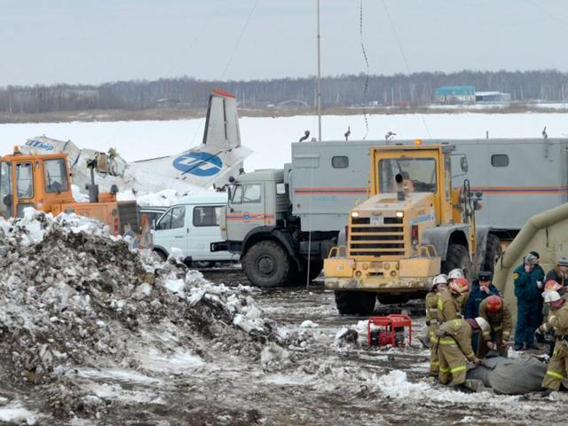 Russian Emergency ministry rescuers and police officers search the site of the ATR-72 plane crash outside Tyumen, a major regional center in Siberia, Russia. AP