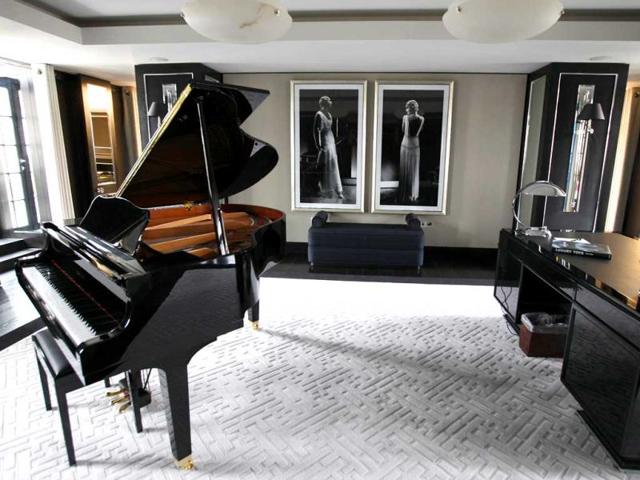 A reception room with baby grand piano and large desk in one of the five bedroom luxury penthouse apartments overlooking Hyde Park, London which is available for hire during the London 2012 Olympics for some 11,000 pounds a night - and includes a maid a butler and and Aston Martin car. AP Photo/Alastair Grant