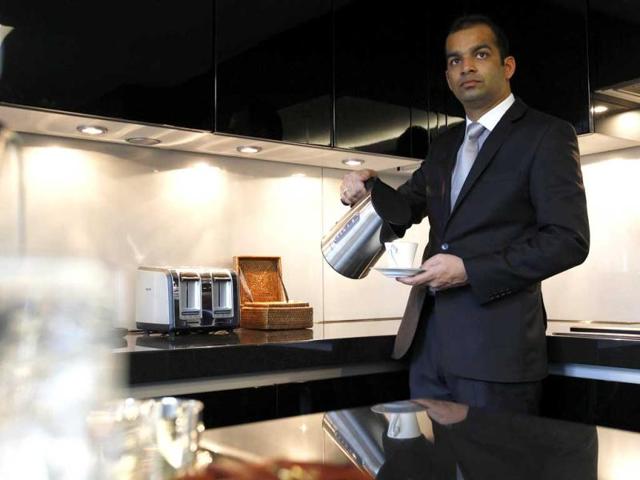 A butler seen in the kitchen of a luxury apartments overlooking Hyde Park, London which is available for hire during the London 2012 Olympics for some 11,000 British pounds (US$17,600) a night - and includes a maid a butler and and Aston Martin car. AP Photo/Alastair Grant