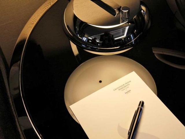 A pen and note paper with the address of the luxury apartments available for hire during the London 2012 Olympics for some 11,000 British pounds a night - and includes a maid a butler and and Aston Martin car. AP Photo/Alastair Grant