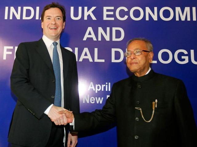 Finance minister Pranab Mukherjee (R) shakes hands with his British counterpart George Osborne before a meeting in New Delhi. AP Photo/ Mustafa Quraishi