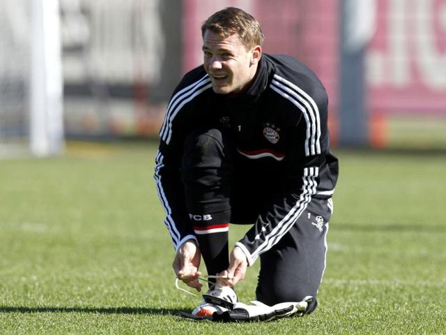Munich goalkeeper Manuel Neuer ties his shoe during a training session in Munich, southern Germany. AP Photo/Matthias Schrader