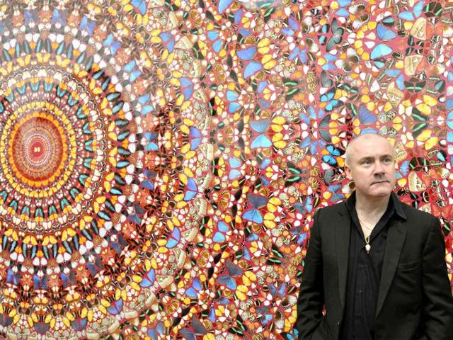 British artist Damien Hirst poses next to his painting I Am Become Death, Shatterer of Worlds (2006), at the Tate Modern gallery in London. Hirst's retrospective show runs from April 4 to September 9. Reuters/Toby Melville