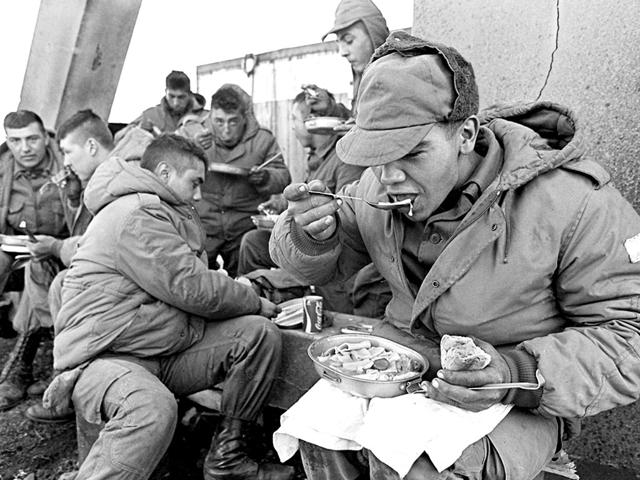 (FILE) File picture shows Argentine soldiers having lunch at the partially destroyed former Royal Marines base, on April 13, 1982 in Stanley. More than 900 people died, including 655 Argentines, 255 British troops and three islanders, before Argentine forces surrendered on June 14, 1982. AFP/Daniel Garcia