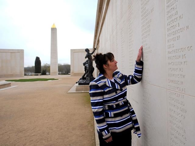 Margaret Allen, wife of British serviceman Iain Boldy, who was killed in an Argentine attack on his ship HMS Argonaut during the Falklands conflict on May 21, 1982, poses for pictures as she looks at his name engraved on a memorial at the National Memorial Arboretum in Staffordshire, central England. AFP/Andrew Yates