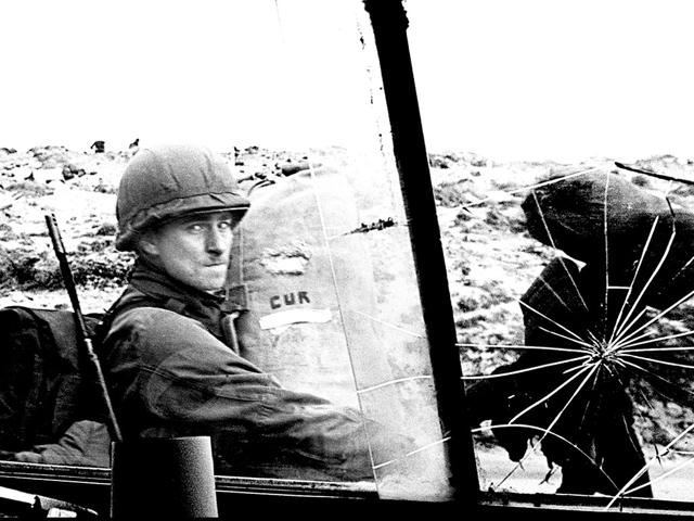 (FILE) File picture shows an Argentine soldier through the window of a military vehicle as he leaves the airport carrying supplies on 13 April 1982. AFP/Daniel Garcia