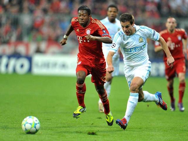 Bayern's David Alaba of Austria, left, and Marseille's Cesar Azpilicueta challenge for the ball during a Champions League quarter final second leg soccer match between FC Bayern Munich and Olympique de Marseille in Munich, southern Germany. (AP Photo)