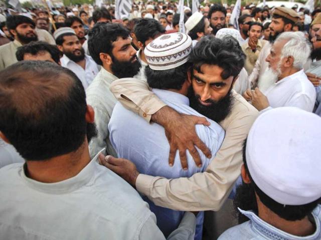 Supporters of the banned Islamic organization Jamaat-ud-Dawa embrace each other after taking part in a funeral prayer for al Qaeda leader Osama bin Laden in Karachi May 3, 2011. Reuters/Athar Hussain