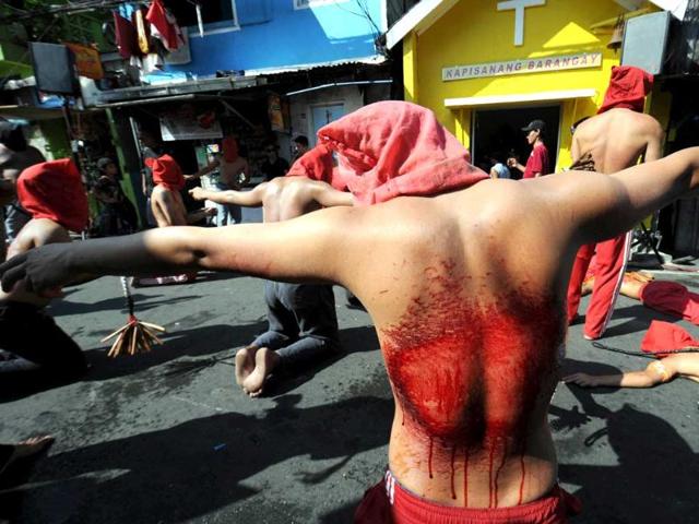 Penitents flagellate themselves as part of Lenten observance in Manila. The dominant Roman Catholic church frowns on flagellation and other extreme acts of penitence including gory Good Friday reenactments of the crucifixion of Jesus Christ, but devout Catholics say it is a means of atoning for their sins and to implore God to spare them and other members of their families from illness or bad luck. AFP Photo/Ted Aljibe.
