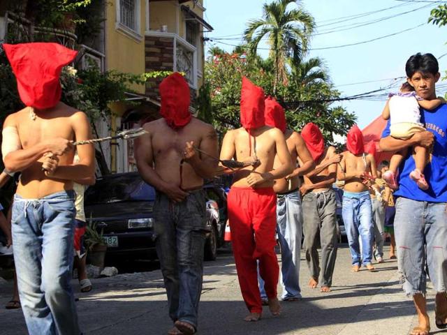 Hooded penitents whip themselves in a ritual to atone for their sins in observance of Holy Week at Mandaluyong city, east of Manila, Philippines. AP Photo/Bullit Marquez.