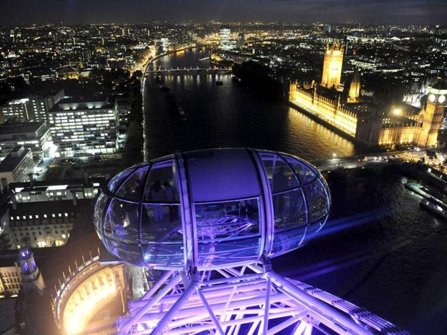 Passengers in a pod of the London Eye wheel view The Houses of Parliament and the centre of London at dusk. Reuters/Toby Melville, Files