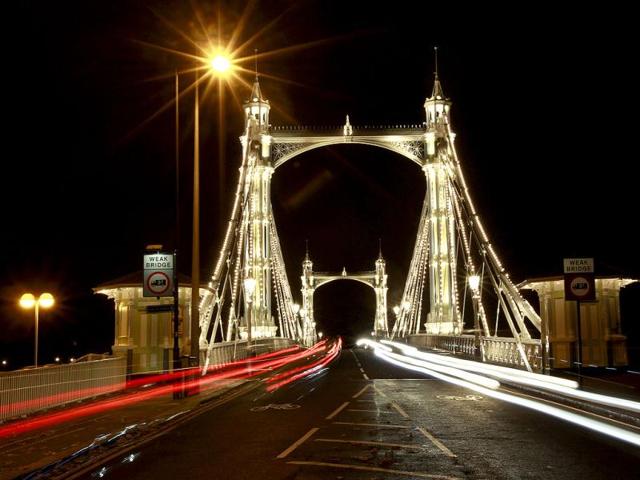 Cars drive over Albert Bridge in London. The bridge is over the River Thames in West London, connecting Chelsea on the north bank to Battersea on the south bank. Reuters/Suzanne Plunkett, Files