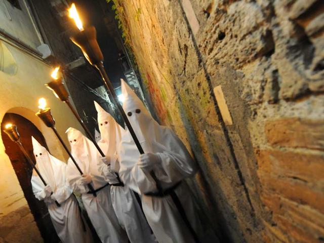 Penitents walk and sing during a Good Friday procession in Sorrento. Christian believers around the world mark the Holy Week of Easter in celebration of the crucifixion and resurrection of Jesus Christ. AFP/Mario Laporta