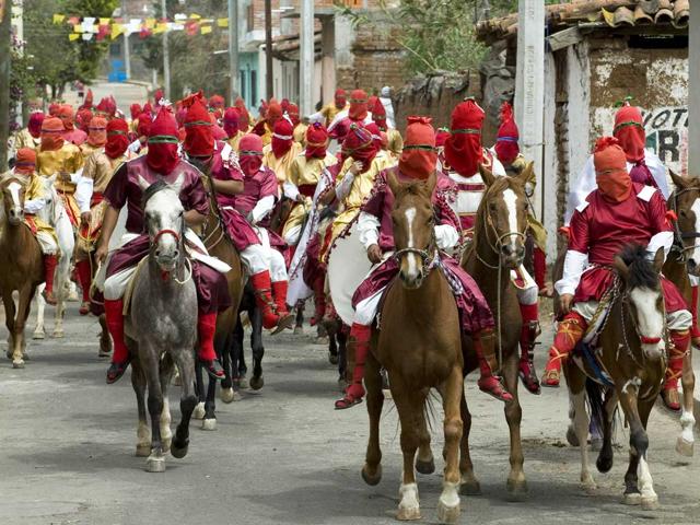 Actors perform the Via Crucis in Tzintzuntzan community in Michoacan, Mexico. The actors are called "Espias" (spies), and ride around the community searching for Christ. AFP/Alfredo Estrella