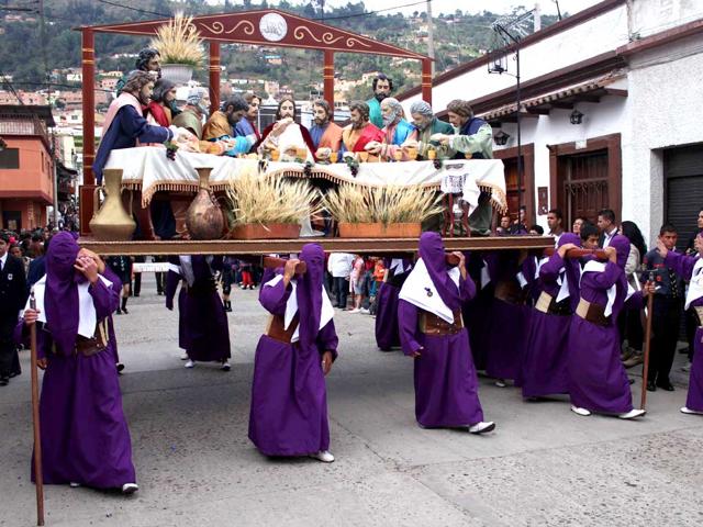 Penitents carrying a statue depecting "The Last Dinner" take part in a Holy Week procession. AFP/Manuel Hernandez