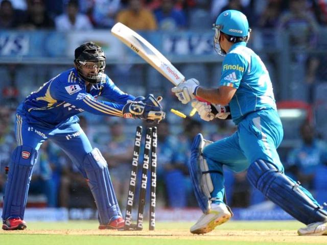 Mumbai Indians wicketkeeper Dinesh Karthik (L) stumps Pune Warriors India batsman Sourav Ganguly during the IPL Twenty20 cricket match at the Wankhede Stadium in Mumbai. AFP/Indranil Mukherjee