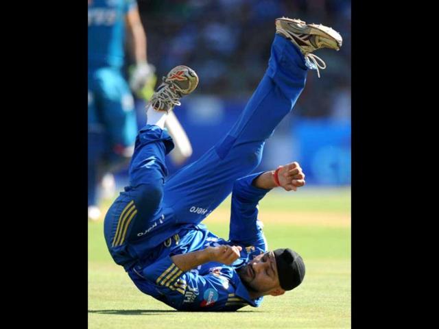 Mumbai Indians captain Harbhajan Singh looks back after failing to stop a shot during the IPL Twenty20 cricket match against Pune Warriors India at the Wankhede Stadium in Mumbai. AFP/Indranil Mukherjee