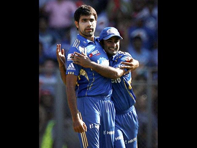 Mumbai Indians bowler Munaf Patel (L) with a teammate celebrates the wicket of Wayne Parnell of Pune Warriors during their IPL T20 match in Mumbai. PTI/Shashank Parade