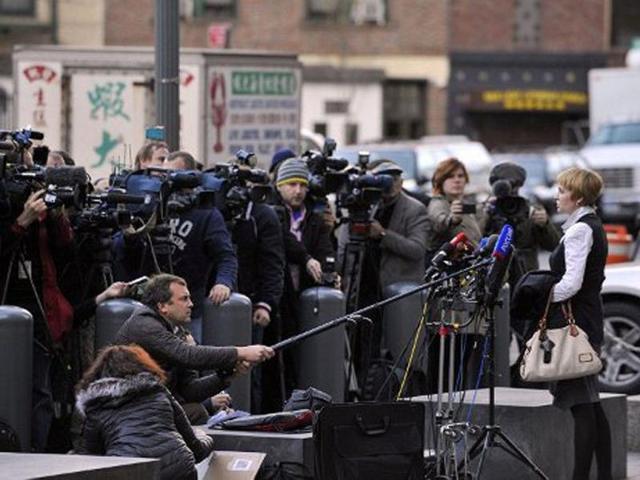 Alla (R), wife of Viktor Bout, speaks to the media outside Manhattan Federal court after her husband was sentenced to 25 years in New York. Bout was convicted of conspiring to sell millions of dollars worth of weapons, including anti-aircraft missiles, to men he believed were terrorists intending to kill Americans. AFP PHOTO / STEPHEN CHERNIN