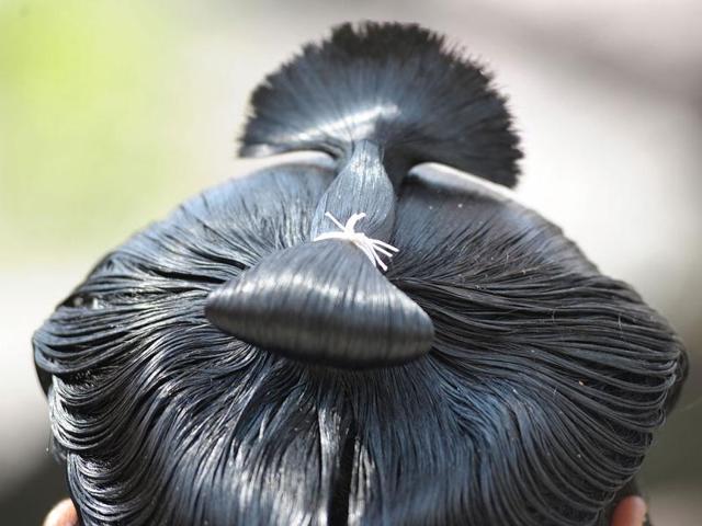 The 'top knot' of a sumo wrestler's hair is pictured as he attends the exhibition at Yasukuni shrine in Tokyo. AFP/Richard A Brooks