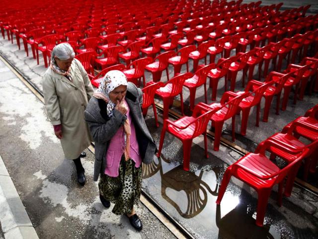 Women walk past some of the 11,541 red chairs along Titova street in Sarajevo, as the city marks the 20th anniversary of the start of the Bosnian war. Reuters photo/Dado Ruvic
