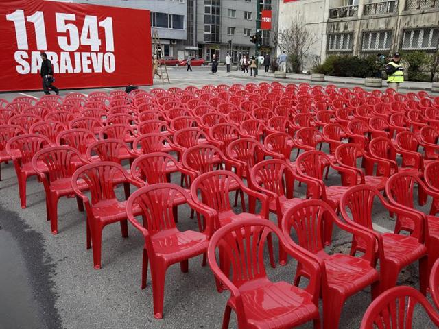 Red chairs are displayed along a main street in Sarajevo as the city marks the 20th anniversary of the start of the Bosnian war. City officials have lined up 11,541 red chairs arranged in 825 rows along the main street that now looks like a red river representing the 11,541 Sarajevans who were killed during the siege. AP Photo/Amel Emric