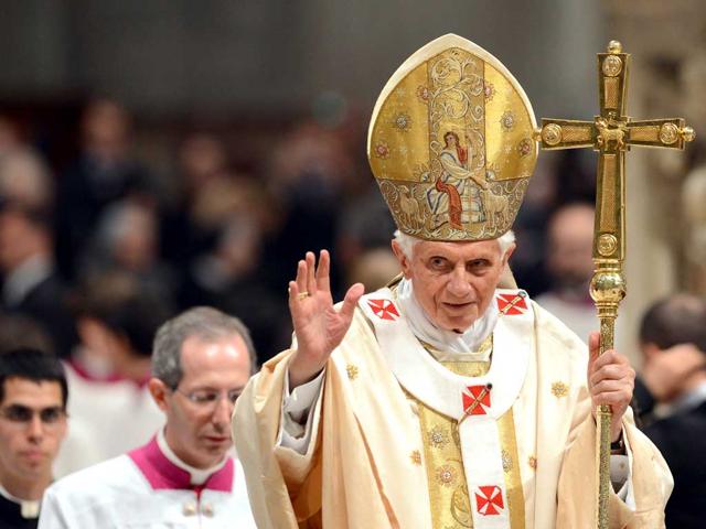 Pope Benedict XVI waves at the end of the Easter Vigil on Holy Saturday at St Peter's basilica at The Vatican. AFP/Vincenzo Pinto