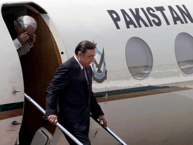 Pakistan President Asif Ali Zardari with the country's high commissioner to India Shahid Malik disembarks as they arrive at AFS Palam in New Delhi. PTI Photo/Kamal Singh