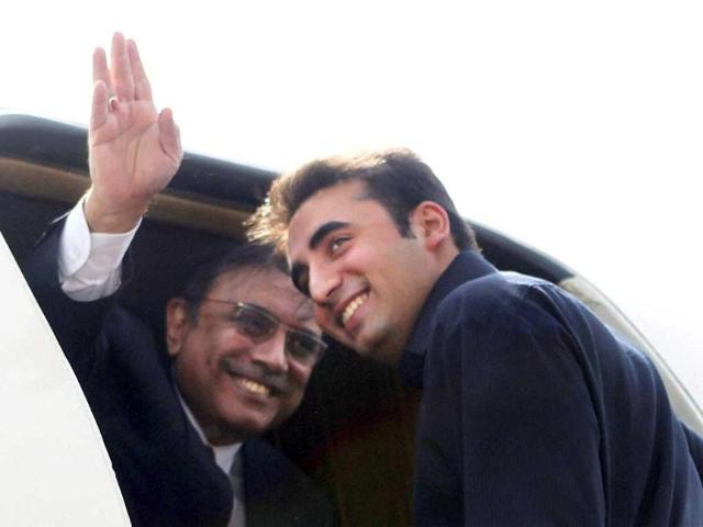 Pakistan President Asif Ali Zardari waves from his plane as he along with his son and Pakistan People's Party chief Bilawal Bhutto Zardari prepares to leave for Jaipur from AFS Palam in New Delhi. PTI Photo by Subhav Shukla