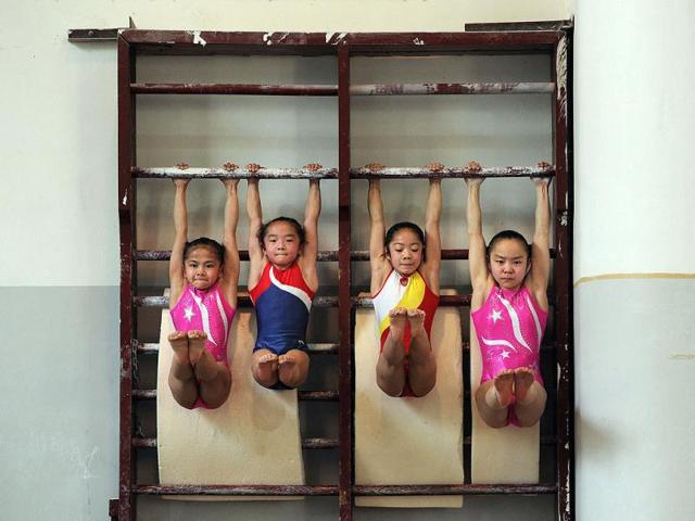 Young Chinese gymnasts train at a special sport school in Hefei, east China's Anhui province. Potential gymnasts embark on a gruelling schedule which aims to create champions. AFP photo