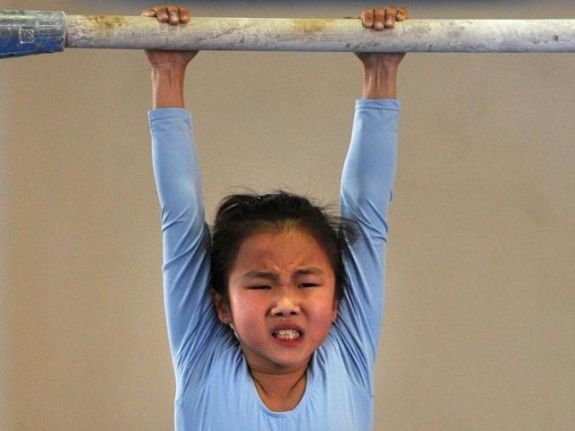 Young gymnast trains at a special sport school in Hefei, east China's Anhui province. Potential gymnasts embark on a gruelling schedule which aims to create champions. AFP photo