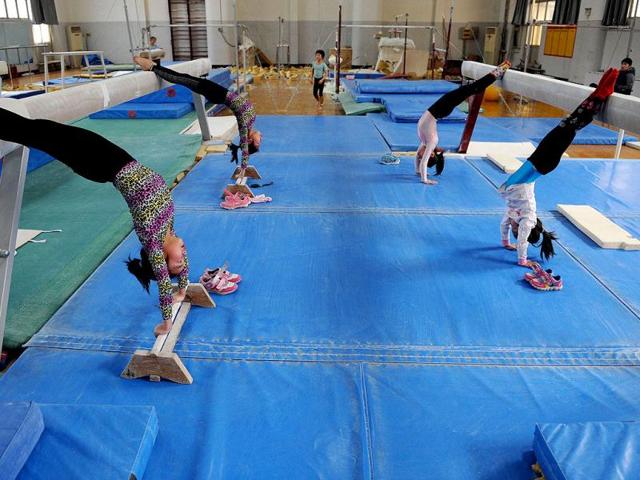 Young Chinese gymnasts train at a special sport school in Hefei, east China's Anhui province. Potential gymnasts embark on a gruelling schedule which aims to create champions. AFP photo