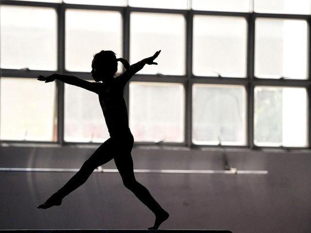 Young Chinese gymnast trains at a special sport school in Hefei, east China's Anhui province. Potential gymnasts embark on a gruelling schedule which aims to create champions. AFP photo
