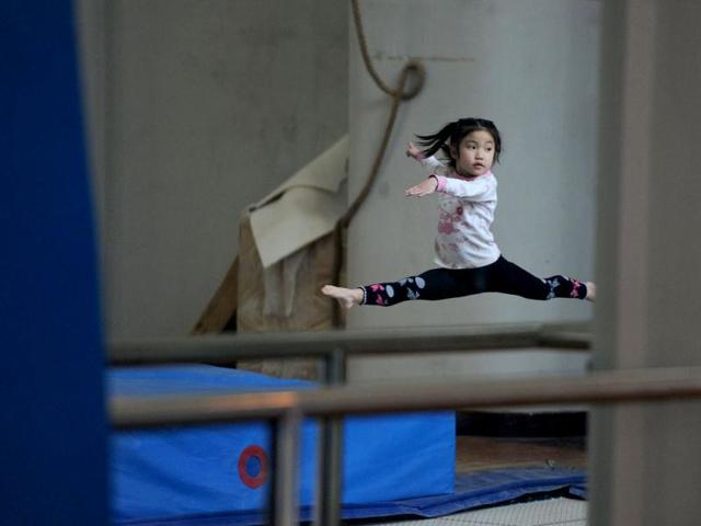 Young Chinese gymnast trains at a special sport school in Hefei, east China's Anhui province. Potential gymnasts embark on a gruelling schedule which aims to create champions. AP Photo