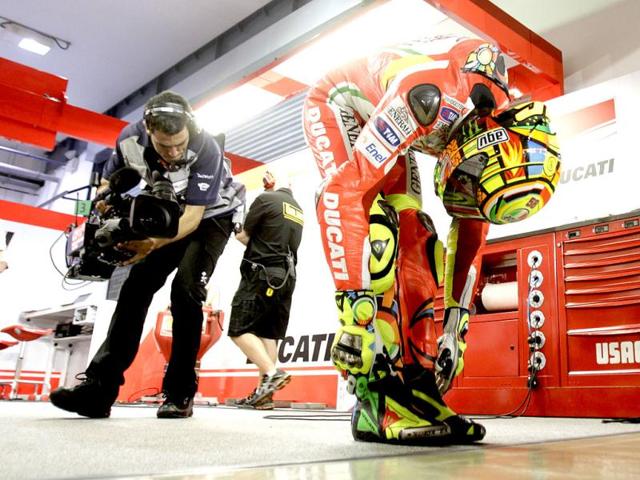 Valentino Rossi of Italy stretches before the qualifying session at the Qatar MotoGP Grand Prix at Losail International Circuit in Doha. Reuters