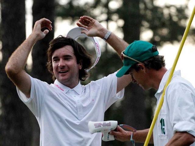 Bubba Watson of the United States celebrates with his caddie Ted Scott after winning his sudden death playoff on the second playoff hole to win the 2012 Masters Tournament by one stroke at Augusta National Golf Club in Augusta, Georgia.