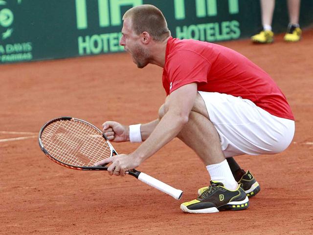 Austria's Oliver Marach celebrates after defeating Spain's Marcel Granollers and Marc Lopez with teammate Alexander Peya during the third game of the Davis Cup World Group quarterfinal round in Oropesa, Spain.. Marach and Peya won the match. AP Photo/Alberto Saiz