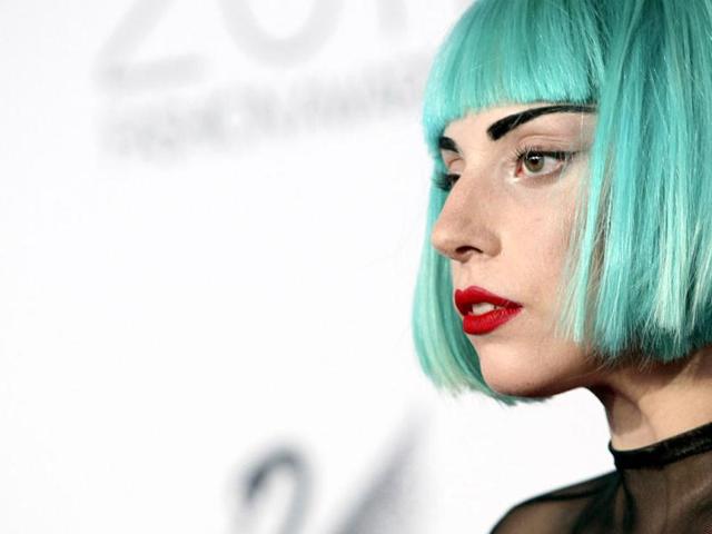 Lady Gaga sips a drink during a news conference in New Delhi. Lady Gaga was on a visit to India, where she was a part of the star-studded unveiling of the country's first Formula 1 race in 2011. Reuters