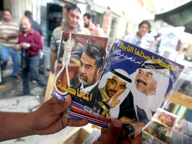 A street vendor shows CDs with the portraits of former Iraqi president Saddam Hussein and his son Uday (C) in the capital Baghdad as Iraq marks the ninth anniversary of fall of Baghdad in the 2003 US-led invasion of Iraq. AFP Photo/Ahmad Al-Rubaye