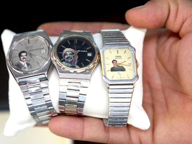 An Iraqi shopkeeper shows watches bearing pictures of former president Saddam Hussein in the capital Baghdad in the ninth anniversary of fall of Baghdad in the 2003 US-led invasion of Iraq. AFP Photo/Ahmad Al-Rubaye