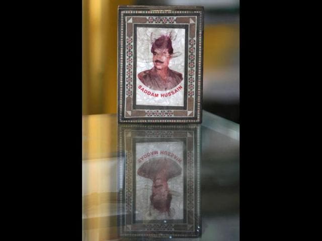 A portrait of former Iraqi president Saddam Hussein in an inlaid frame is displayed in a windowshop in the capital Baghdad as Iraq marks the ninth anniversary of fall of Baghdad in the 2003 US-led invasion of Iraq. AFP Photo/Ahmad Al-Rubaye
