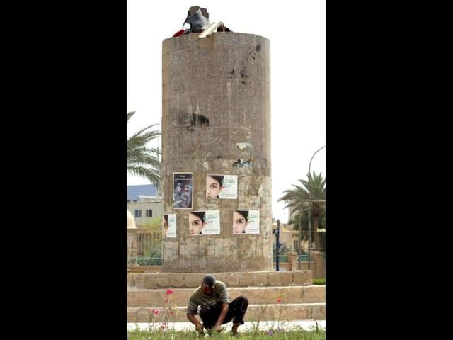An Iraqi municipality employee works on the garden of Firdous square, where the statue of former Iraqi president Saddam Hussein used to stand, in the capital Baghdad as Iraq marks the ninth anniversary of fall of Baghdad in the 2003 US-led invasion of Iraq. AFP Photo/Ahmad Al-Rubaye