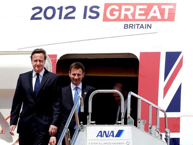 British Prime Minister David Cameron (L) arrives at Haneda Airport in Tokyo. Cameron kicked off his tour of Asia, starting with his visit to Japan with an eye for closer joint development of weapons and military equipment. AFP/Toru Yamanaka