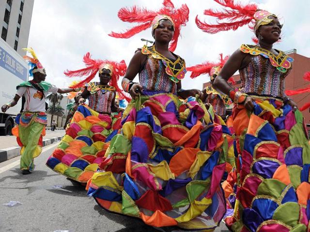 People dance in a procession during the yearly Lagos carnival. The yearly Lagos carnival to celebrate the Easter festival and the rich cultural heritage of the state was held in Lagos metropolis. AFP PHOTO / PIUS UTOMI EKPEI