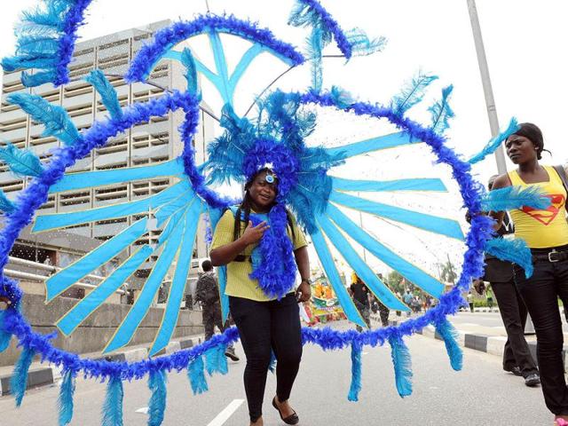 A woman dances in procession during the yearly Lagos carnival. The carnival celebrates the Easter festival and the rich cultural heritage of of the state . AFP PHOTO: PIUS UTOMI EKPEI