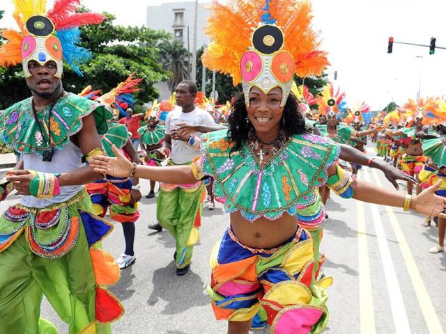 People dance in a procession during the yearly Lagos carnival. The yearly Lagos carnival to celebrate the Easter festival and the rich cultural heritage of the state was held in Lagos metropolis. AFP PHOTO / PIUS UTOMI EKPEI